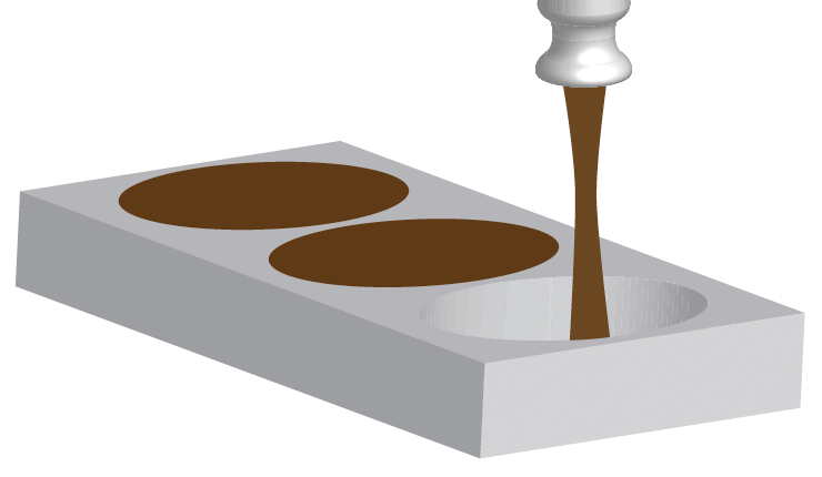 Chocolate is added to an egg mould to help make easter eggs
