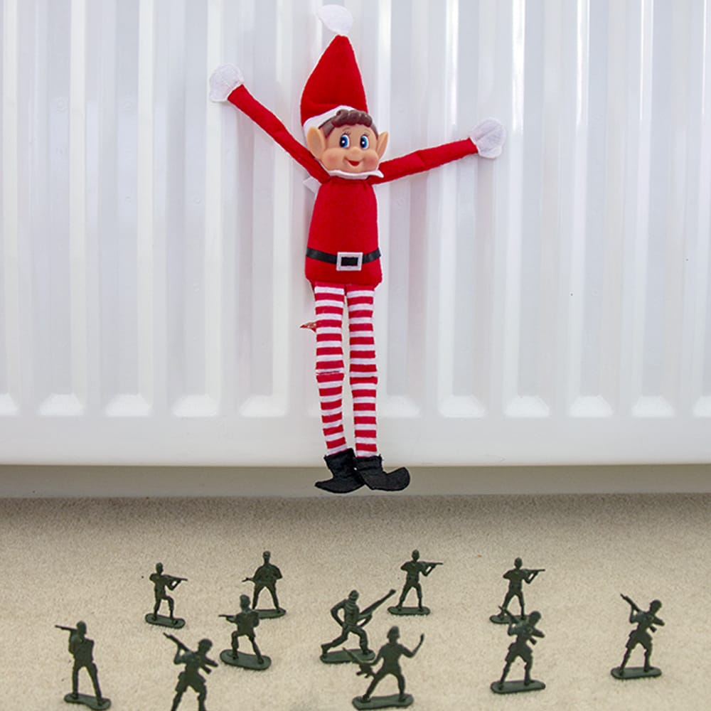 Elf on the shelf hanging from a radiator